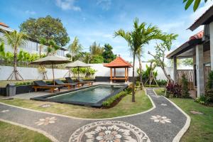 a backyard with a swimming pool and a gazebo at Ulu Apsura Villas in Uluwatu