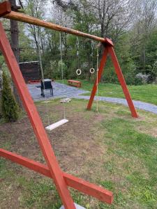 a swing set in a park with a playground at Domek pod Besidą in Czarna