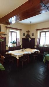 a room with a large table with chairs and windows at Stanglwirt Frühstückspension in Göstling an der Ybbs
