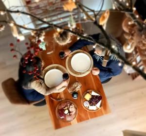 a table with a cup of coffee and food on it at La Cabane du Gardien in Marche-en-Famenne
