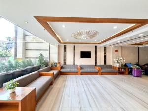 a large lobby with couches and a tv in a building at Queen Ann Hotel in Ho Chi Minh City
