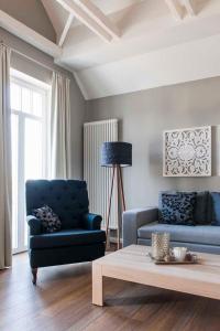 a living room with a blue couch and a coffee table at "Villa Minerva" Ferienwohnung 09 in Kühlungsborn