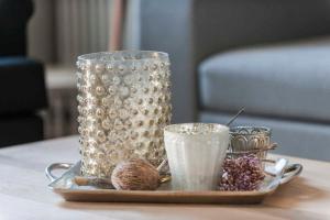 a tray with two glasses and some nuts on a table at "Villa Minerva" Ferienwohnung 09 in Kühlungsborn