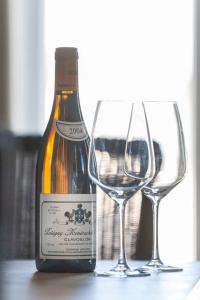 a bottle of wine sitting next to two wine glasses at "Villa Minerva" Ferienwohnung 09 in Kühlungsborn +22 photos