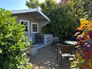 a small shed with a table and chairs in a yard at "Ferienhaus Großenaspe" in Großenaspe