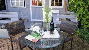 a table with a book and wine glasses on a patio at "Ferienhaus Großenaspe" in Großenaspe
