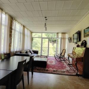 a living room with a couch and a table at Riviera Guesthouse in Dilijan