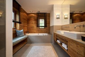 a bathroom with a tub and a sink at Chalet-F in Ofterschwang +71 photos