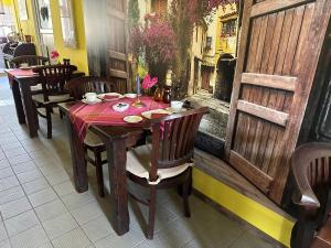 a table in a restaurant with a red table cloth at Bed & Breakfast am Waldgürtel in Forst
