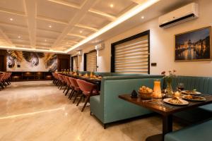 a long dining room with a long table and chairs at Vijay Vilas by Arow Hotels and Resorts in Pushkar