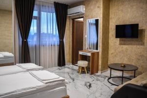 a hotel room with a marble floor and a bedroom at Стаи за гости- Maria Elegance in Pavel Banya