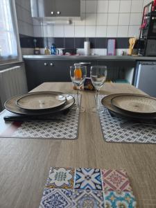 a table with two plates and wine glasses on it at point baie studio 1 in Abbeville