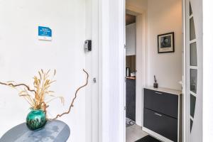 a room with a table with a vase on it at Lavignottes - AC - Piscine & Tennis in Labouheyre