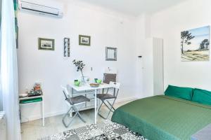 a bedroom with a bed and a desk with a computer at Lavignottes - AC - Piscine & Tennis in Labouheyre +7 photos