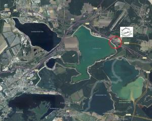 a map of a lake with a red marker at SeeNest Lieske in Lieske