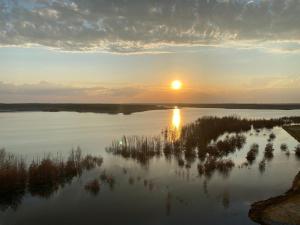 a sunset over a large body of water at SeeNest Lieske in Lieske