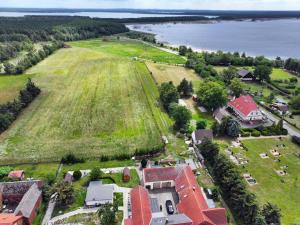 an aerial view of a village with a field and a lake at SeeNest Lieske in Lieske