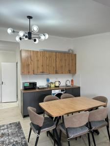 a kitchen with a table and chairs in a room at RADUGA West in Koshkolʼ