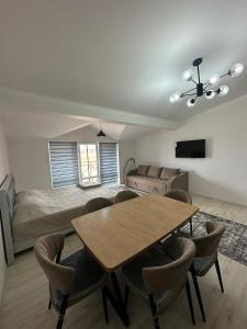 a living room with a table and a bed at RADUGA West in Koshkolʼ