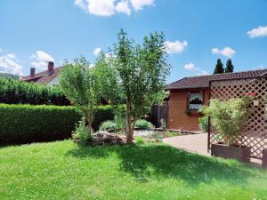 a garden with two trees and a house at Ferienwohnung Edersonne in Hemfurth-Edersee +38 photos