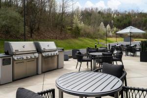 a patio with a grill and tables and chairs at TownePlace Suites by Marriott Corbin in Corbin