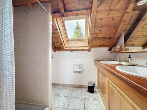 a bathroom with a sink and a shower and a window at Chalet Face aux Etoiles in Molines-en-Queyras +35 photos