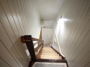 a staircase in a room with white walls and wooden floors at Ferienwohnung Familie Schmidt in Bergen auf Rügen