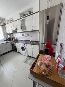 a kitchen with white cabinets and a wooden table at El paraíso I in Raxó +8 photos