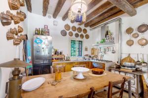 a kitchen with a wooden table and a refrigerator at Villa Colloredo in Dolo