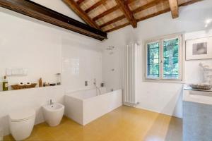 a white bathroom with a tub and a toilet at Villa Colloredo in Dolo +19 photos