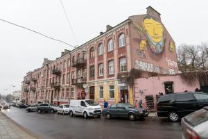 a city street with cars parked in front of buildings at Vilnius Old Town Happiness in Vilnius