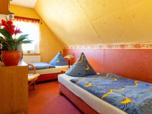 a bedroom with two beds with blue pillows at Ferienwohnung Familie Schmidt in Bergen auf Rügen