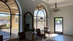 a lobby with two tables and chairs and a mirror at Studio 6 Anaheim Hills CA in Anaheim
