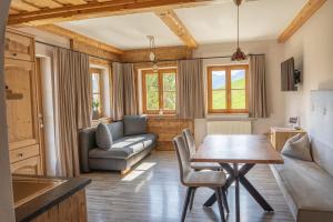 a living room with a table and a couch at Bio Alpenhof Rostatt in Bischofshofen