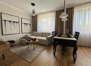 a living room with a table and a couch at Apartament 101 in Piła