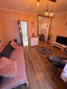 a living room with a couch and a table at POD SOSNAMI - ul Dominicka 28 in Boszkowo