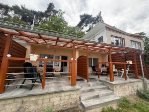 a pergola on a house with a patio at POD SOSNAMI - ul Dominicka 28 in Boszkowo