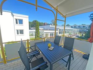 a blue table and chairs on a balcony at Villa Störtebeker - Whg 05 in Baabe
