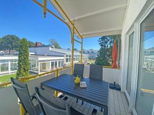 a blue table and chairs on a balcony at Villa Störtebeker - Whg 05 in Baabe