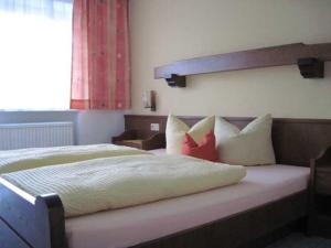 a bedroom with a large bed with pillows on it at Bauernhof Huber in Wenns