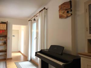 a piano in a living room with a window at Ferienhaus Baumgarten1 in Gnas +52 photos