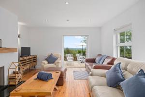 a living room with a couch and a table at Hilltop Views by Escape Ordinary in Killyhevlin