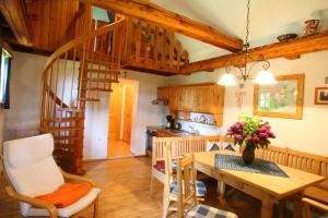 a kitchen and dining room with a wooden table and stairs at Kellerstöckl Leitner in Strem
