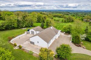 an overhead view of a white barn in a field at Hilltop Views by Escape Ordinary in Killyhevlin