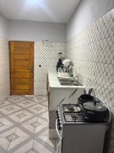 a kitchen with a stove and a sink at Résidence meublée du boss in Abidjan +13 photos