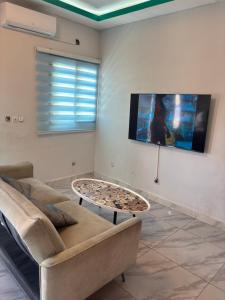 a living room with a couch and a table at Résidence meublée du boss in Abidjan