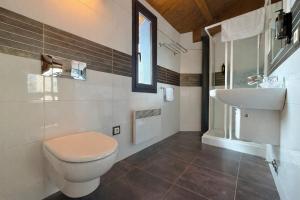 a bathroom with a toilet and a sink at RoomRural Hotel Iru-Bide Lumbier in Lumbier +29 photos
