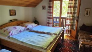a bedroom with a wooden bed with a window at Ferienhaus Pilz Marion in Bad Goisern