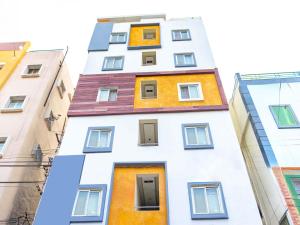 a tall white building with colorful windows at Z Express Zen Elite in Pune