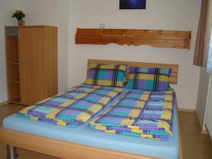 a bed in a room with two pillows on it at Ferienwohnung Jirkal in Sankt Martin bei Lofer